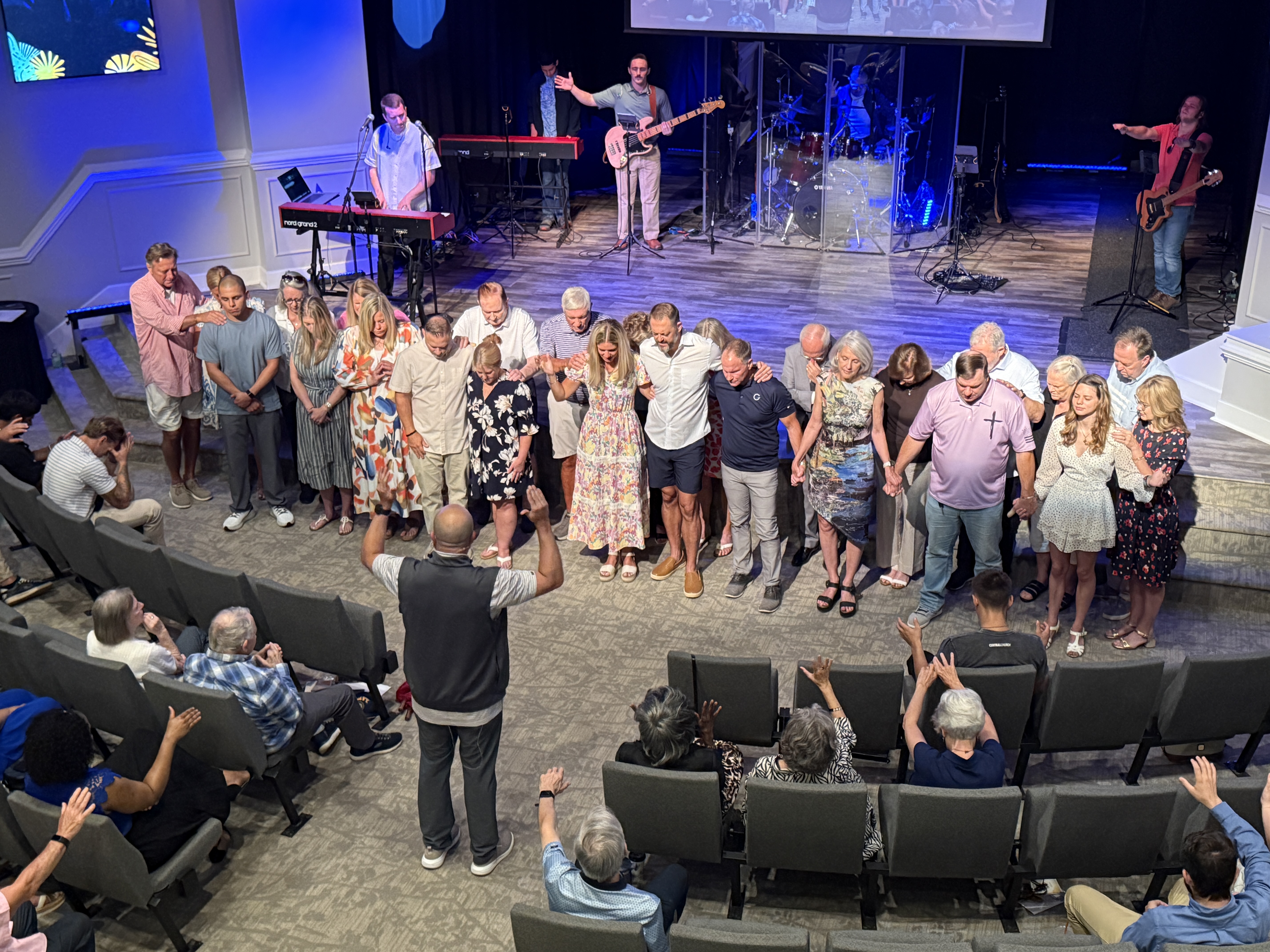 The congregation praying with hands raised