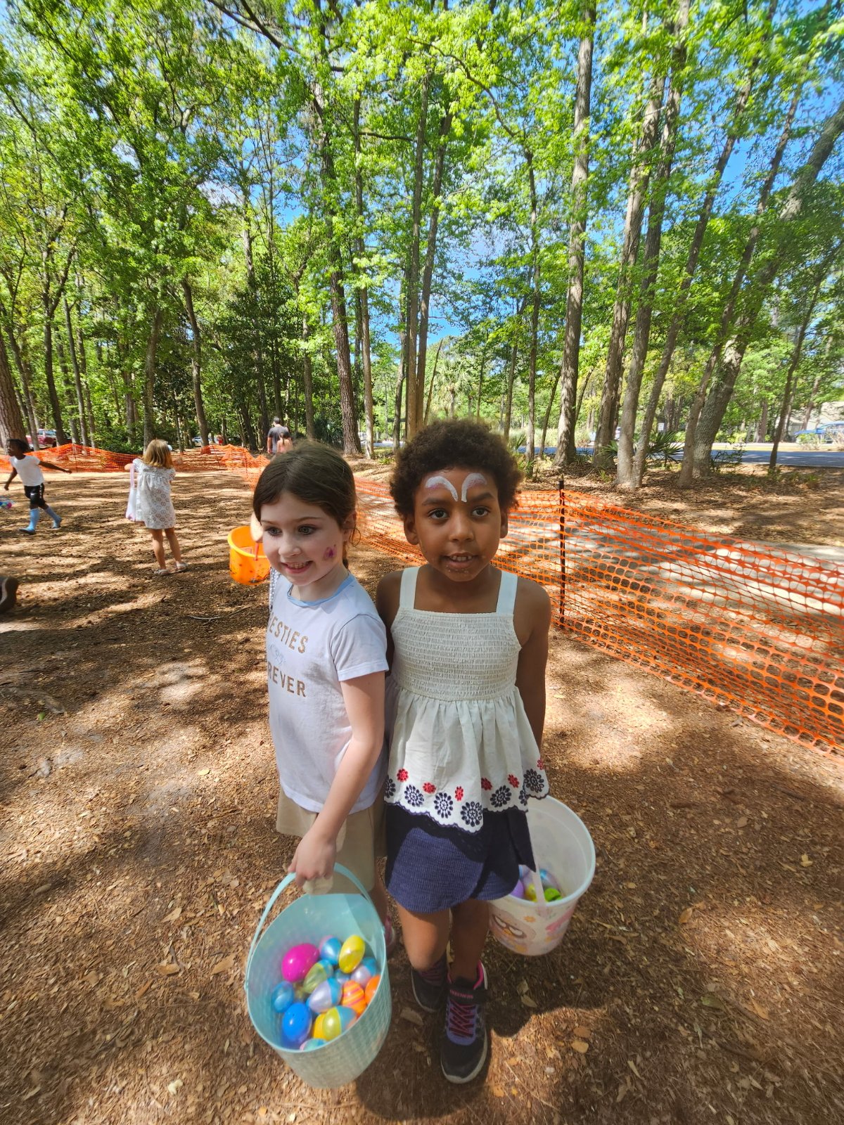 Two kids showing off their Easter baskets