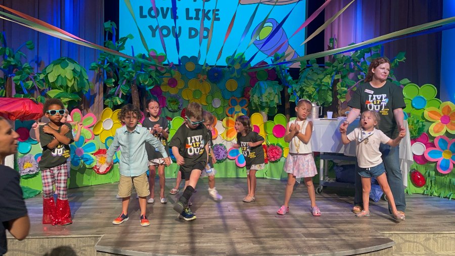 Kids dancing on stage at VBS