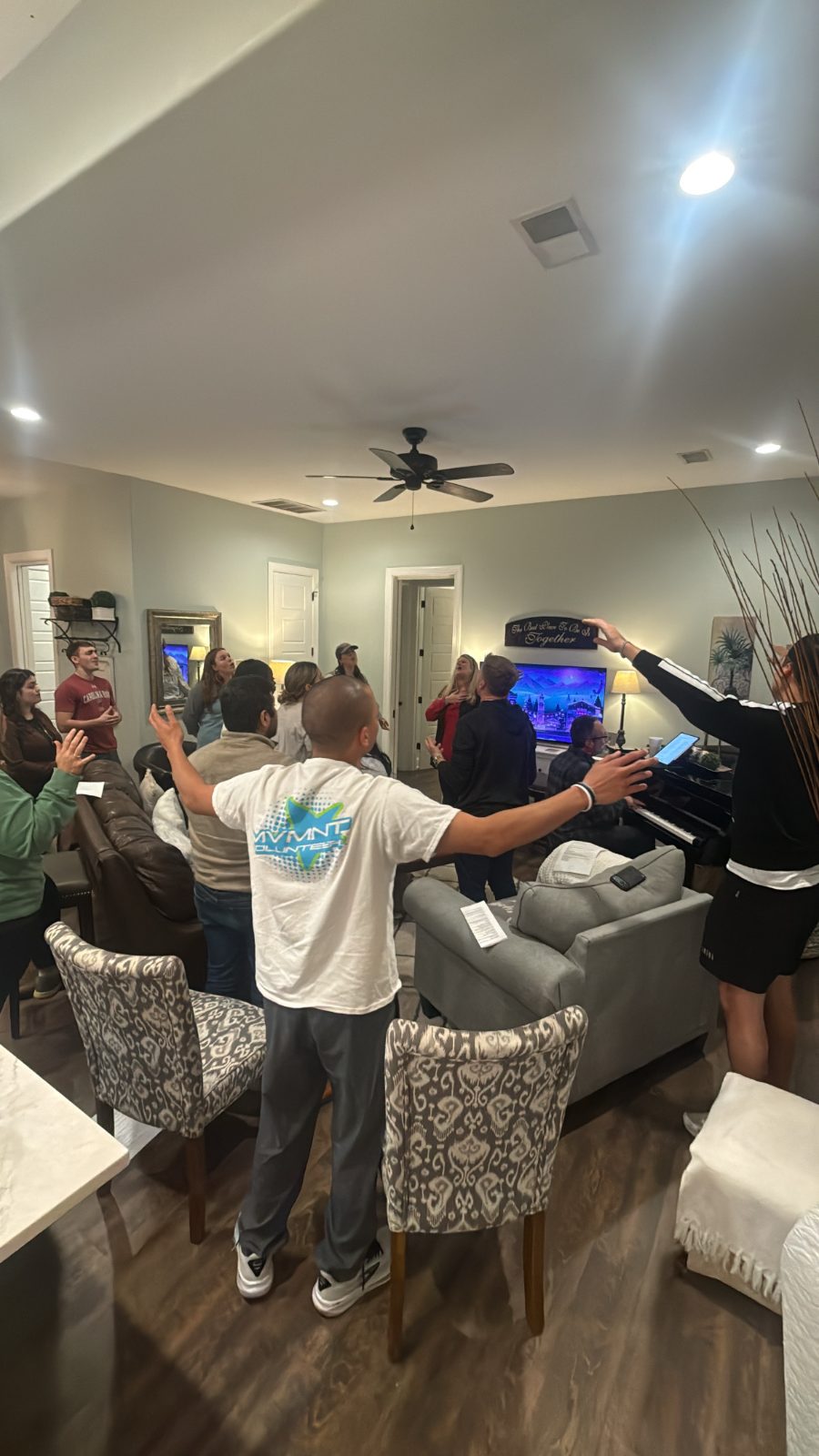 Young adults worshiping with hands raised